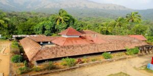 Thirunelli Temple in Wayanad, Kerala – historic Vishnu temple nestled in the Brahmagiri hills, showcasing traditional Kerala-style architecture with sloping tiled roofs, wooden carvings, and surrounded by lush green forests and valleys, a major pilgrimage site.